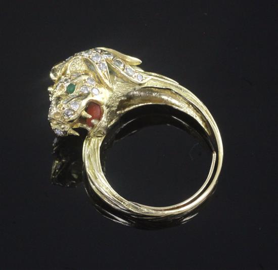 A gold, diamond and gem set lions head ring, size Q.